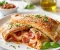 صورة مقال 🍕🇮🇹 بيتزا كالزوني -  طريقة تحضير الكالزوني الإيطالي المحشو بالجبن والصلصة